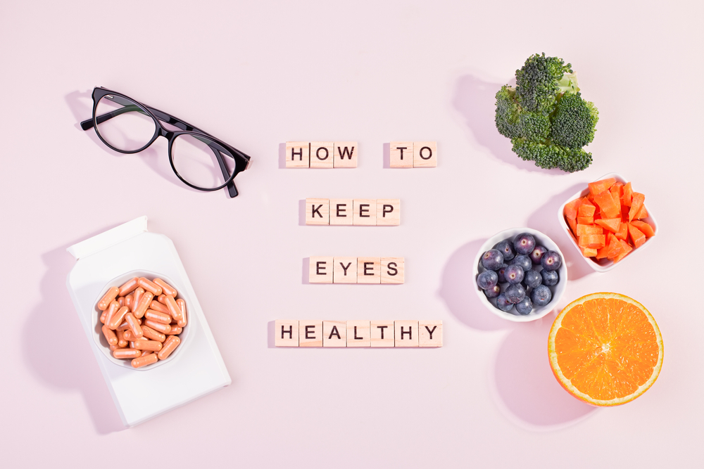 Glasses, vitamins, broccoli, blueberries, carrots & an orange surrounding the text "how to keep eyes healthy". 